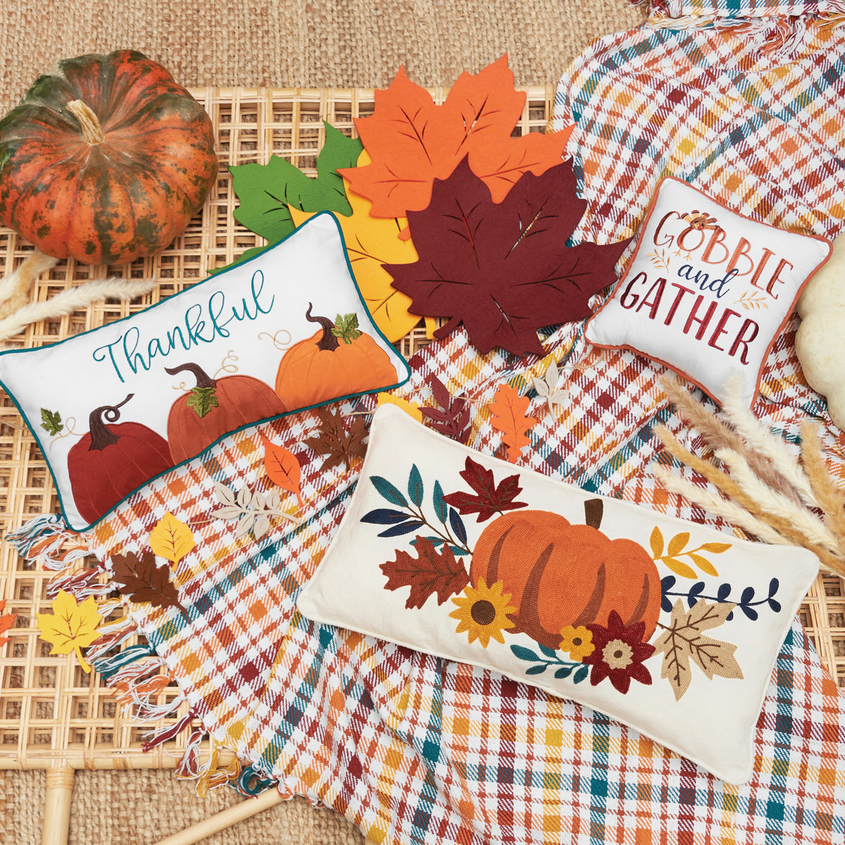 Harvest flat lay of embellished pumpkin pillows.