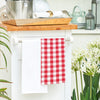 woven red and white checkered gingham kitchen towel hanging from a kitchen countertop