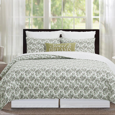 quilt with watercolor inspired foliage pattern that reverses to a coordinating rain drop pattern