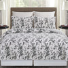 intricate black floral quilt with a crosstitch pattern on the reverse side