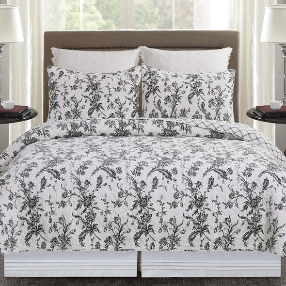 intricate black floral quilt with a crosstitch pattern on the reverse side
