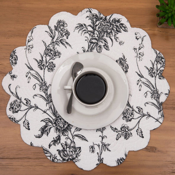 quilted table linen collection with an intricate black floral pattern that reverses to a simple plaid