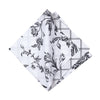 quilted table linen collection with an intricate black floral pattern that reverses to a simple plaid