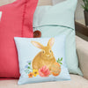 blue floral bunny pillow on a couch with a blue and pink pillow