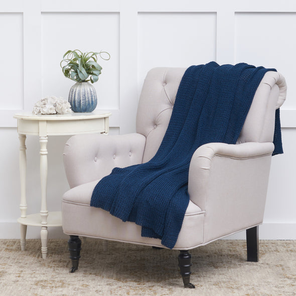 knitted indoor outdoor navy throw on a chair