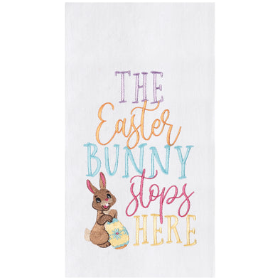 flour sack towel with the phrase the easter bunny stops here in flourishing typography that is bright and colorful next to a smiling bunny holding a decorated easter egg