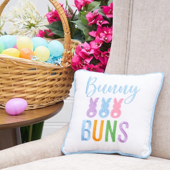 bunny buns pillow on a chair with easter decor on the side table