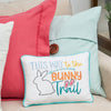 bunny trail pillow on a couch with a blue and pink pillow
