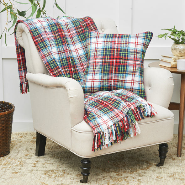 Morris plaid woven throw and matching pillow styled on a wingback chair.