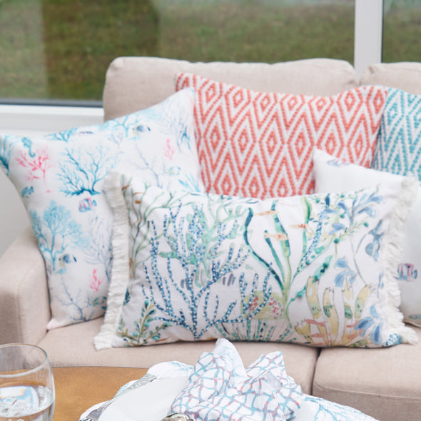 coastal pillows in bright colors on a couch