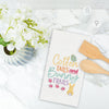 embroidered waffle weave towel with the words cotton tails and bunny trails surrounded by easter icons on a marble counter