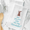 flour sack towel is the phrase Did you see who ate my chocolate below a chocolate bunny with bites taken from its ears. the towel is on a marble counter