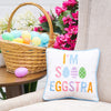 eggstra pillow in a chair with an easter basket on the side table
