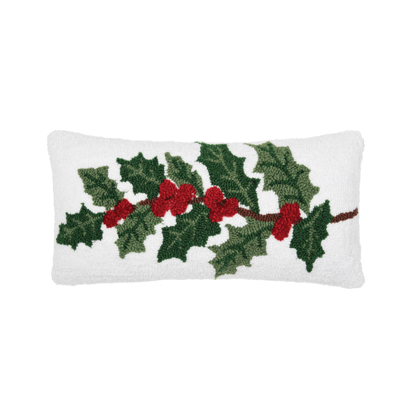 white hooked pillow with a red and green holly berries and leaves across the front