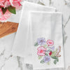 flour sack towel with an array of hibiscus flowers and a graceful hummingbird drinking from the blooms on a marble counter