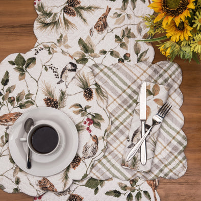 quilted table linen collection featuring a pattern with charming chickadees and wrens perched among twigs of green leaves, acorns, berries, and pinecones that reverses to a coordinating plaid