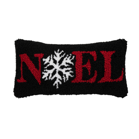 a black hooked pillow with the word Noel written in red. the O in Noel is replaced with a white snowflake