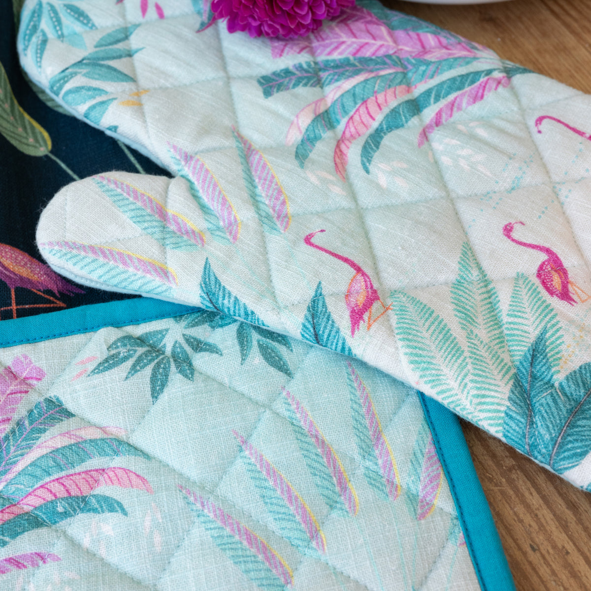 A flamingo palms oven mitt & potholder set.
