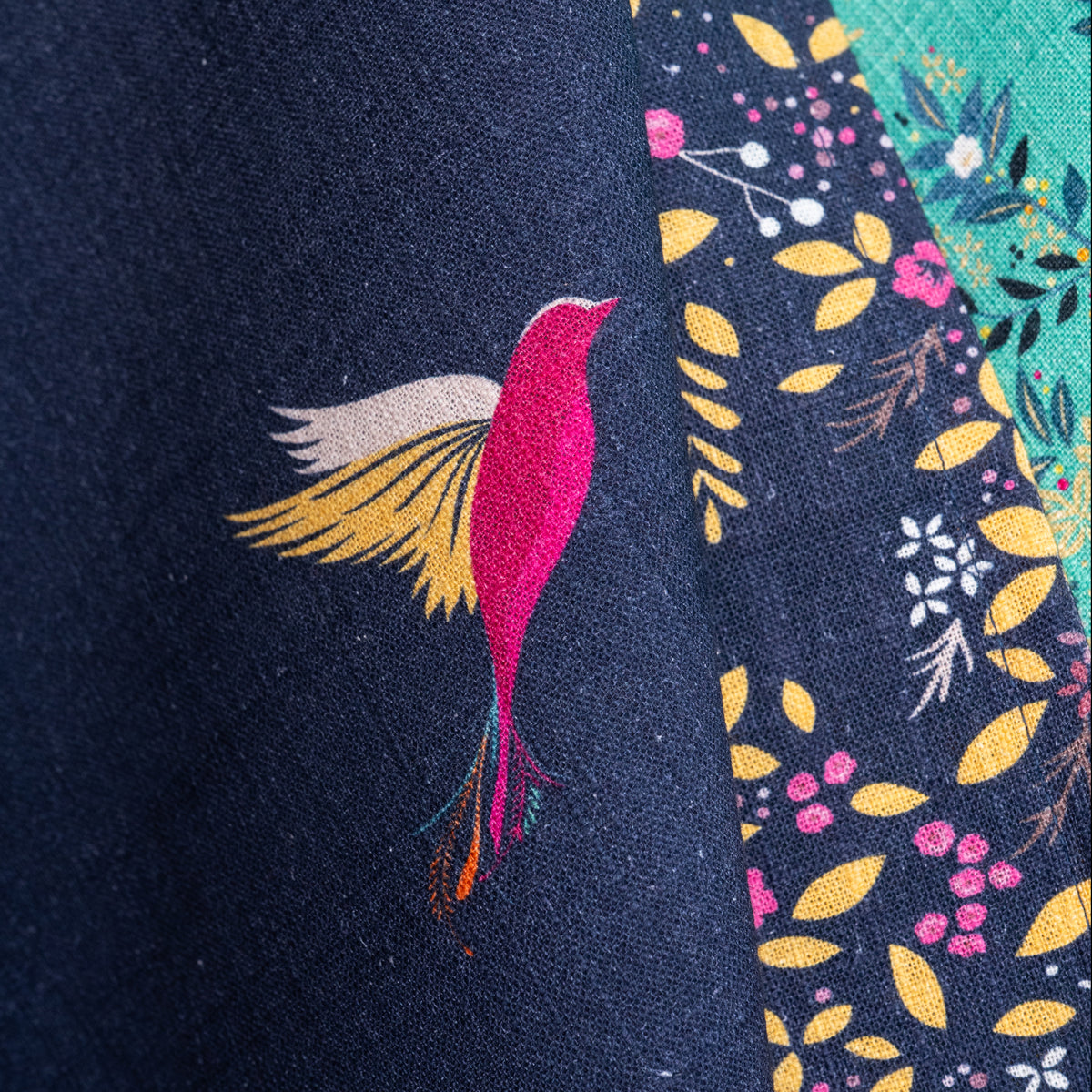 A navy hummingbird screen printed towel.
