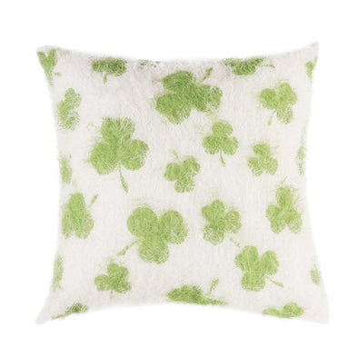green shamrocks on a white fuzzy textured pillow