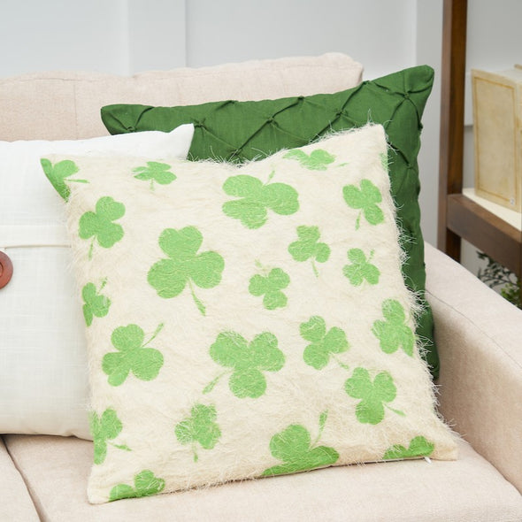 shamrock pillow on a couch with a green and white pillow