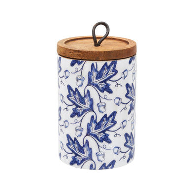 white canister with blue leaves and acorn pattern with a wood lid