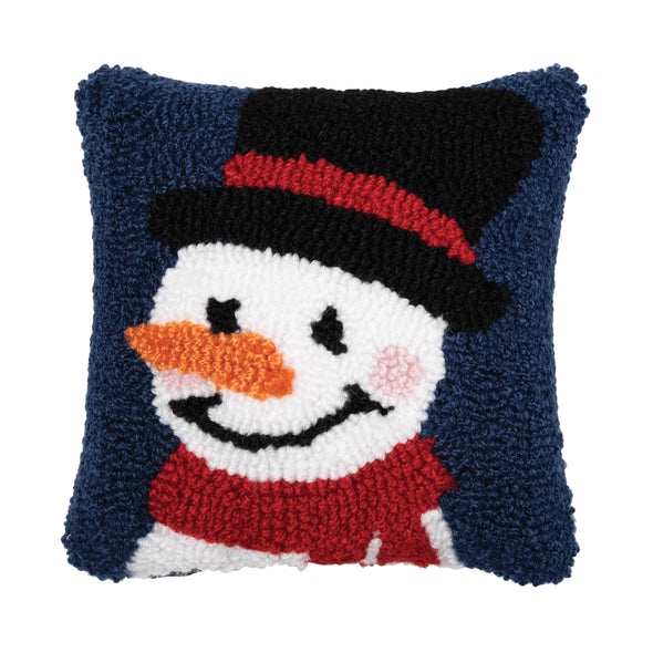 hooked pillow with a snowman supporting a top hat, red scarf, rosy cheeks, and a bright orange nose on a navy blue background