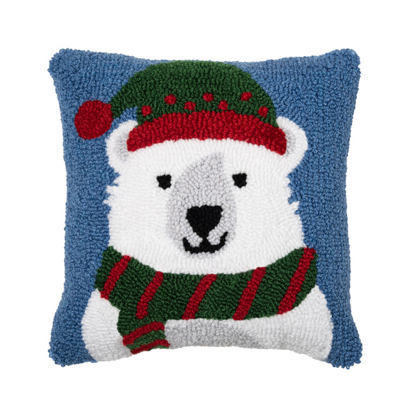 hooked pillow depicting a white polar bear wearing a red and green hat and scarf on a light blue background