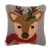 hooked pillow with a reindeer wearing a red scarf with a holly berry and leaf in its antler on a grey background