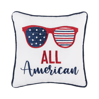 embroidered pillow featuring a pair of sunglasses decorated like the American flag with the words All American underneath on a white background and trimmed in blue