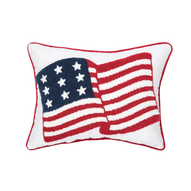 a tufted pillow featuring an American flag as if it was blowing in the wind. the pillow is trimmed in red.