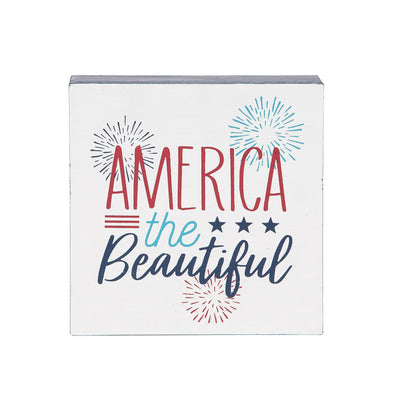 shelf block with the words america the beautiful in flourishing text surrounded by fireworks and three blue stars