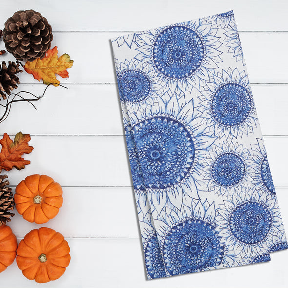 blue sunflower towel on white shiplap with harvest accents (pinecones and pumpkins)