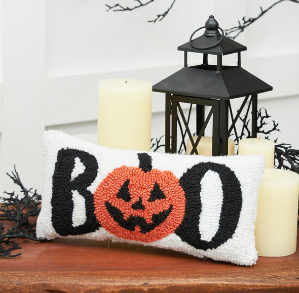 Boo Pumpkin Mini Hooked Pillow styled on a Halloween themed side table.