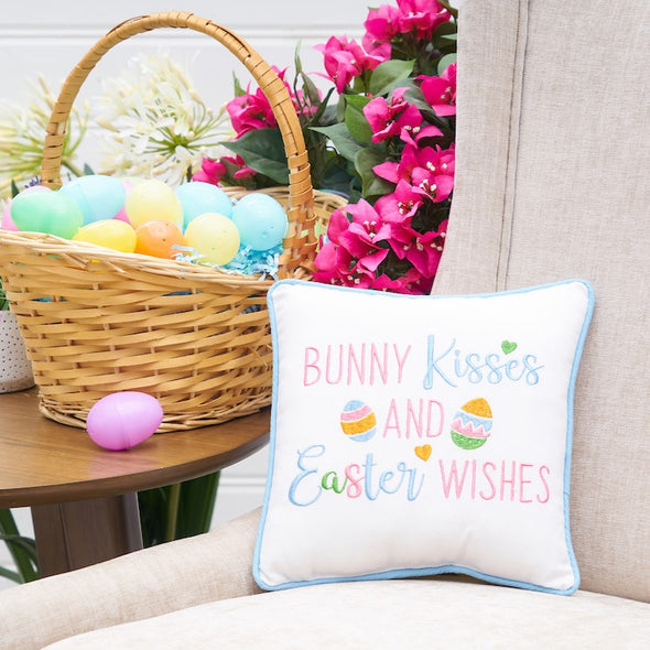 bunny kisses pillow on a chair with an easter basket on the side table