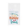 white towel with the words "this way to the bunny trail" with a bunny, bunny feet and an arrow in pastels 