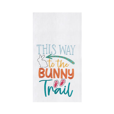 white towel with the words "this way to the bunny trail" with a bunny, bunny feet and an arrow in pastels 