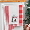 waffle weave towel with the phrase All is Calm All is Bright above an adorable reindeer next to a decorated Christmas tree hanging from a kitchen countertop