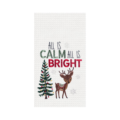 waffle weave towel with the phrase All is Calm All is Bright above an adorable reindeer next to a decorated Christmas tree