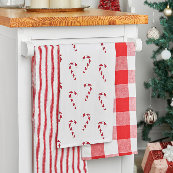 printed kitchen towel with red and white candy canes all over hanging from a kitchen counter