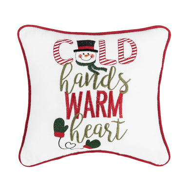 cold hands warm heart mini pillow with the words "cold hands warm heart" in red and green with a snowman as the O and green mittens on the bottom on a white pillow with red trim