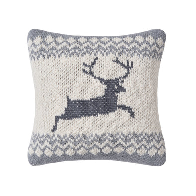 knitted pillow with grey edges and a darker grey deer in the center of a beige background