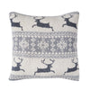 knitted pillow with a natural background and rows of leaping deer and snowflake patterns in light grey