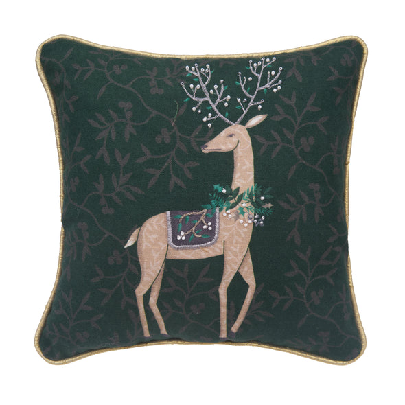 printed and embellished pillow with artwork by Lori Siebert featuring a deer in the center decorated with berries and leaves with ornate antlers. the emerald green background is covered in delicate foliage leaves in a dark grey background.