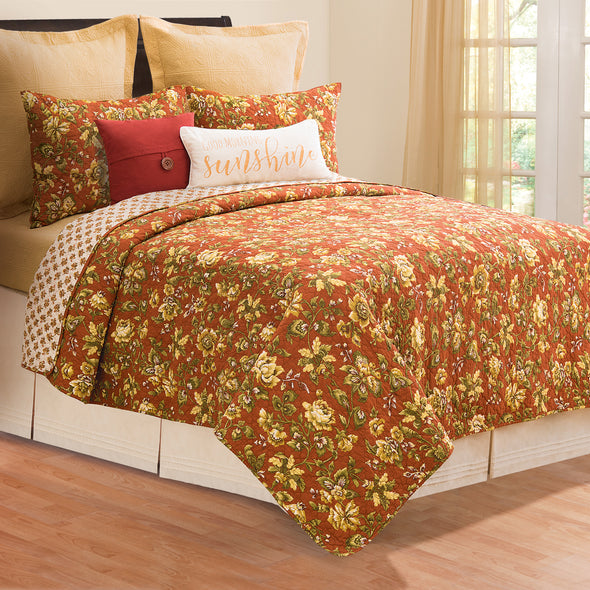 Estelle quilted bedding styled with decorative throw pillows.