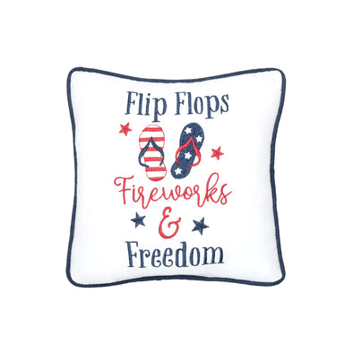 embroidered pillow with the phrase flip flops fireworks and freedom in red and blue with a pair of flip flops designed to resemble an American flag in the center and surrounded by tiny stars.
