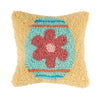 yellow pillow with a decorated easter egg that is shades of blue with a pink flower 