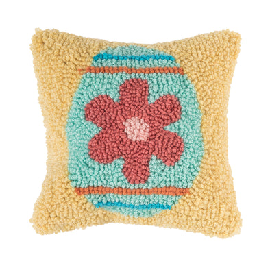 yellow pillow with a decorated easter egg that is shades of blue with a pink flower 