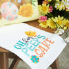 for peeps sake kitchen towel with flowers next to it 