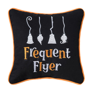 black mini pillow with the words frequent flyer embroidered on it below four witches' brooms